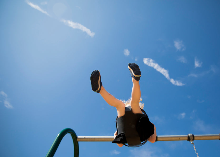a-child-on-a-swing-under-a-blue-sky